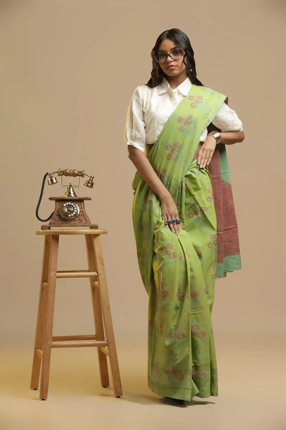 Model posing in the lime green cotton saree against a neutral studio backdrop, highlighting the drape