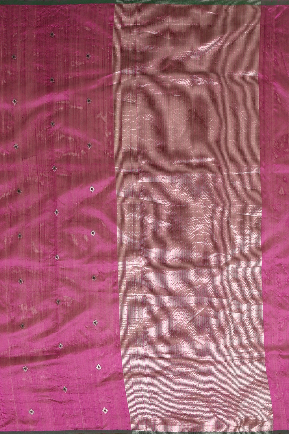 Flat-lay studio arrangement showcasing the intricate zari pallu and weave pattern of the magenta Chanderi pattu silk saree