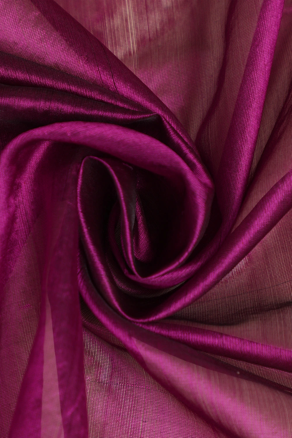 Close-up view of the folded rich magenta pattu silk fabric highlighting its lustrous texture and fine handwoven finish