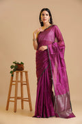 Full-length studio view of a model wearing the magenta handwoven Chanderi pattu silk saree with small green motifs and dark green border, styled with traditional silver jewelry