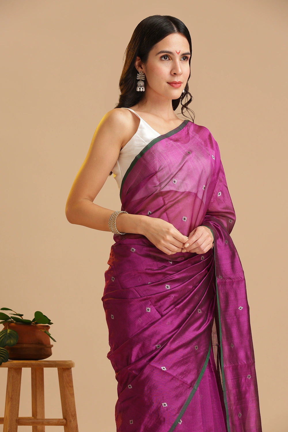 Studio standing angle view showcasing the graceful drape and rich magenta color palette of the Chanderi pattu silk saree