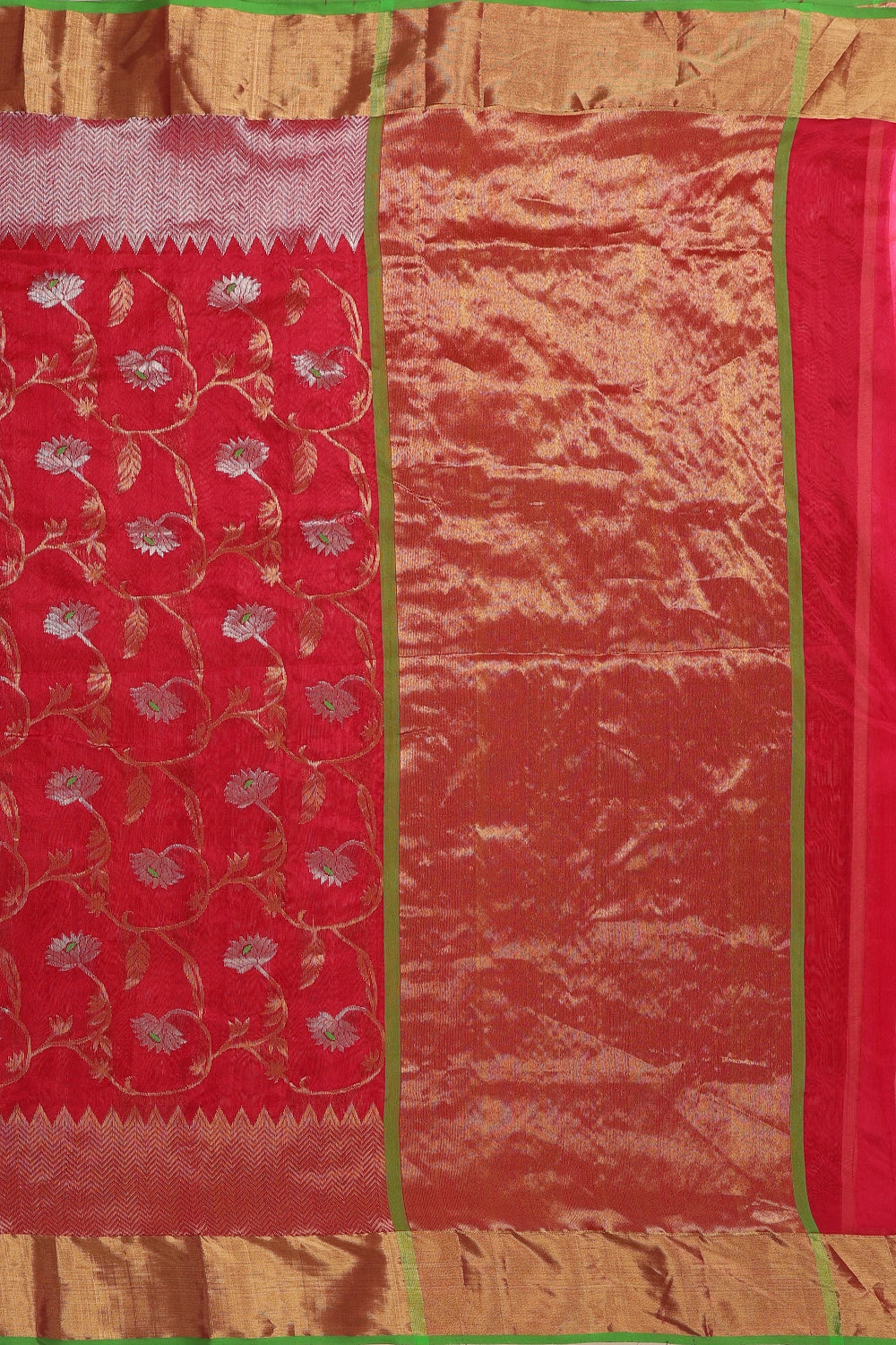 Flat-lay studio arrangement showcasing the intricate golden zari pallu and detailed weave pattern of the Chanderi pattu silk saree